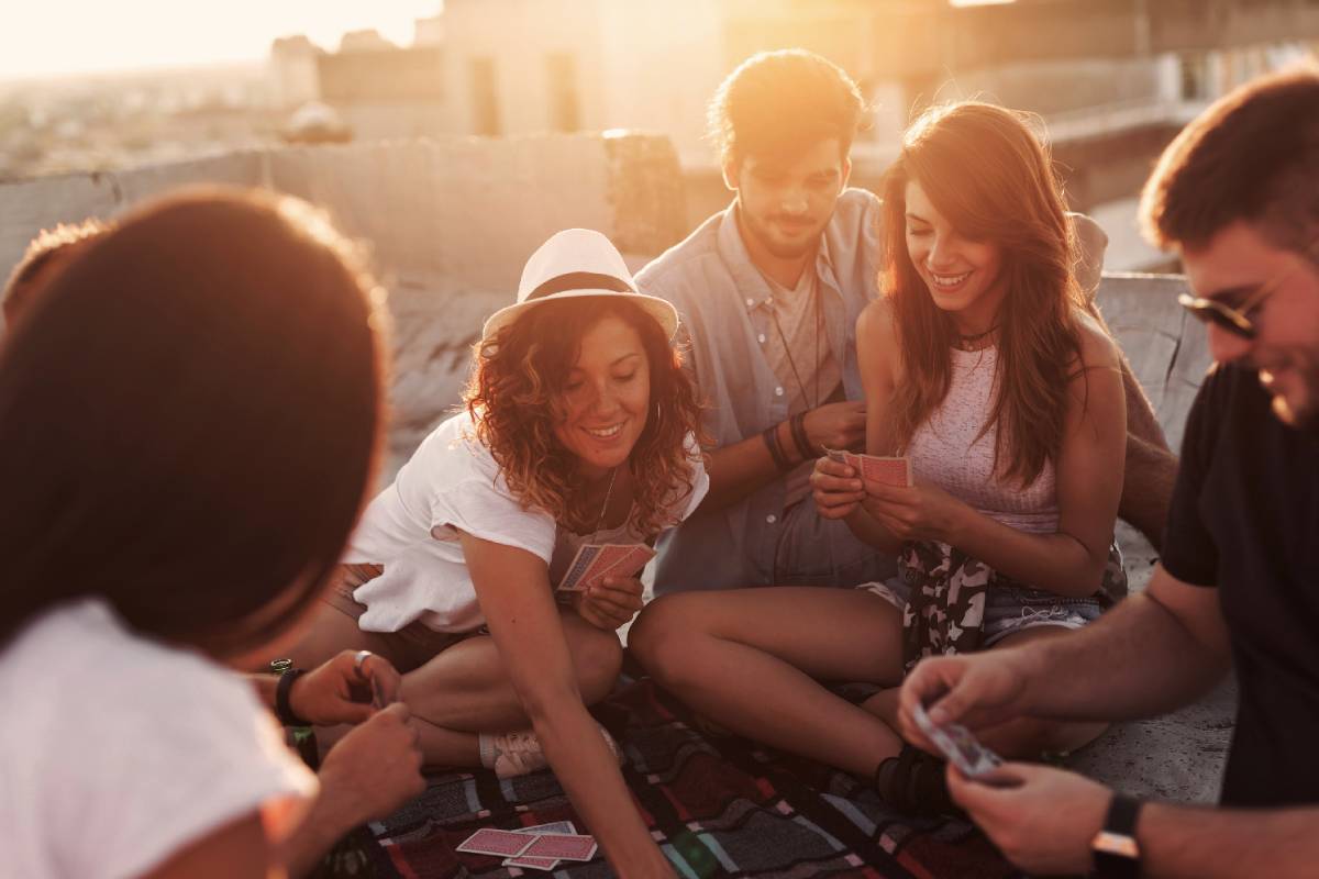 Lifestyle image of a party, people playing cards